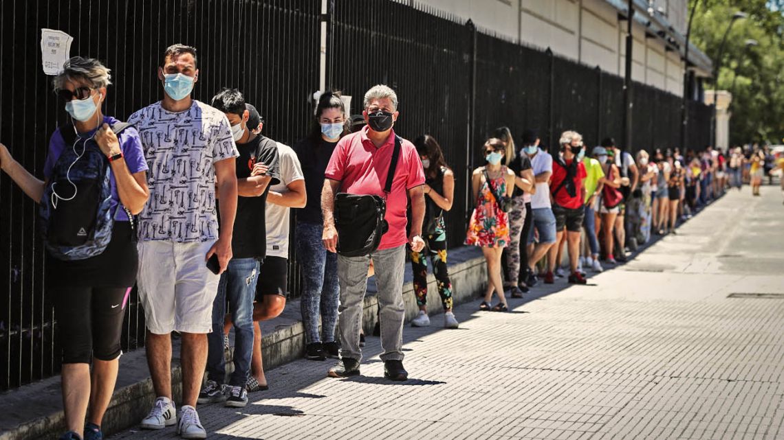 Porteños line up outside La Rural in Buenos Aires as they wait for a Covid test.
