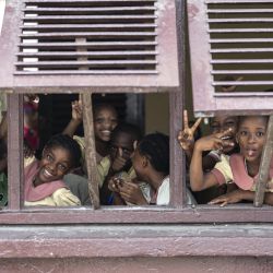 Alumnos posan en una ventana de su escuela en Douala, oeste de Camerún. | Foto:CHARLY TRIBALLEAU / AFP
