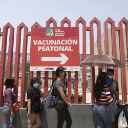 Personas hacen fila para recibir una dosis de una vacuna contra la enfermedad del nuevo coronavirus (COVID-19), en la Villa Deportiva Nacional, en Lima, Perú. | Foto:Xinhua/Mariana Bazo