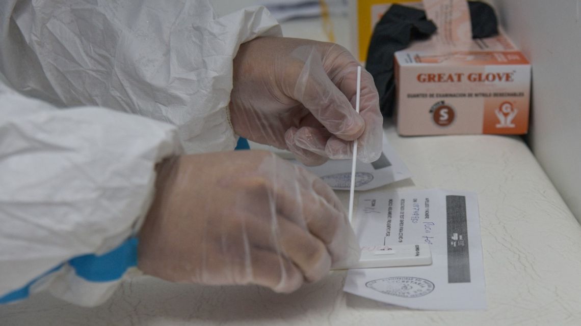 A health worker is seen at a municipal health truck that performs COVID-19 tests in Mar del Plata, Argentina, on January 11, 2022. 