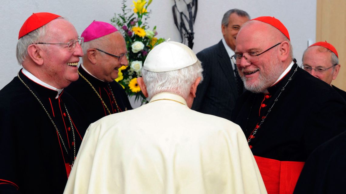 This file photo taken on September 25, 2011, shows then-Pope Benedict XVI (C) chatting with cardinal Friedrich Wetter (L), cardinal archbishop of Munich and Freising Reinhard Marx (R) and Archbishop of Freiburg and head of the German Bishops' Conference Robert Zollitsch (2nd L) during a lunch with members of the German Bishops' Conference (DBK) in Freiburg, southern Germany, on the last day of the Pontiff's first state visit to his native Germany. 