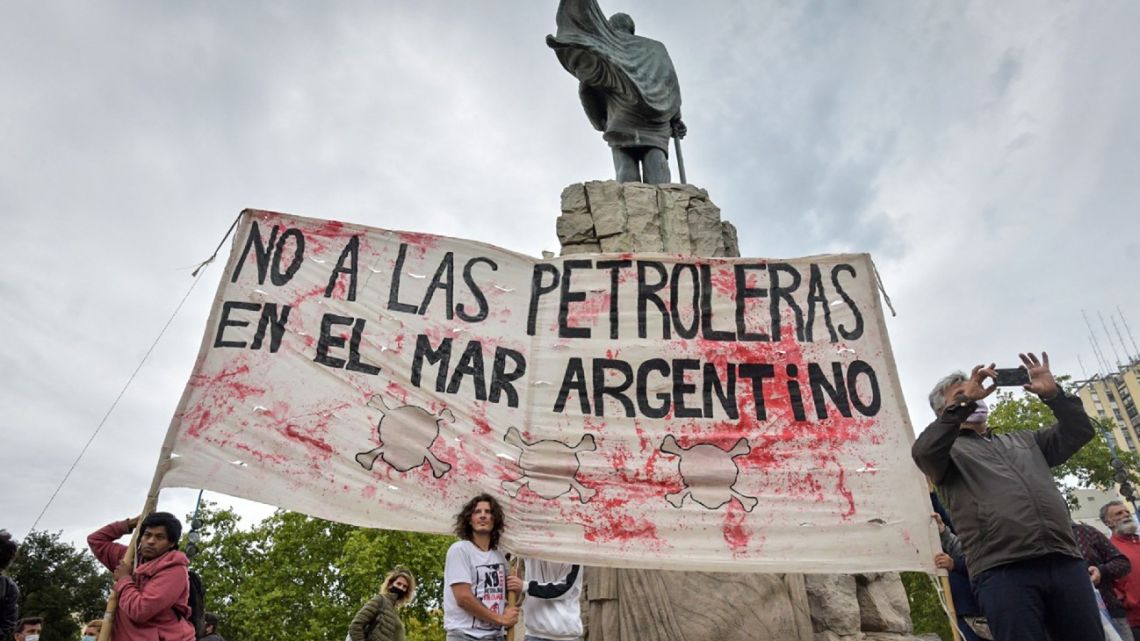 Activists holds a banner reading 'No to Oil Companies in the Argentine Sea' during a demonstration against a project for offshore oil drilling off the coast of Mar del Plata on January 18, 2022