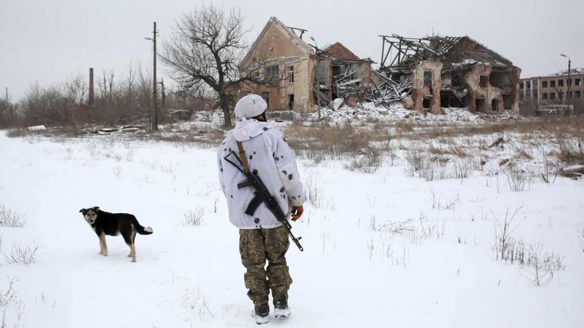 A Ukrainian Military Forces serviceman walks in the Donetsk region village of Peski, close to the front-line with Russia-backed separatists on January 25, 2022.