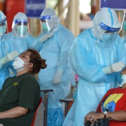 Trabajadores médicos recolectan muestras de hisopado de personas para pruebas de detección de la COVID-19, en Bangkok, Tailandia. | Foto:Xinhua/Rachen Sageamsak