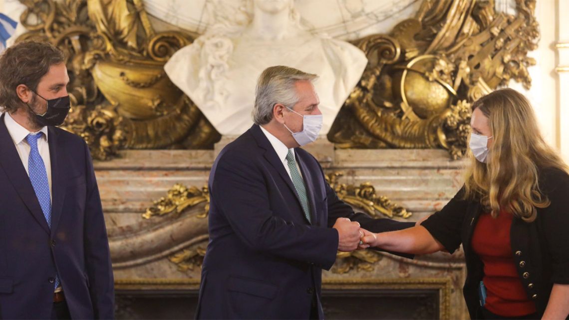 Britain's Ambassador to Argentina Kirsty Hayes presents her credentials to President Alberto Fernández, as Foreign Minister Santiago Cafiero watches on.
