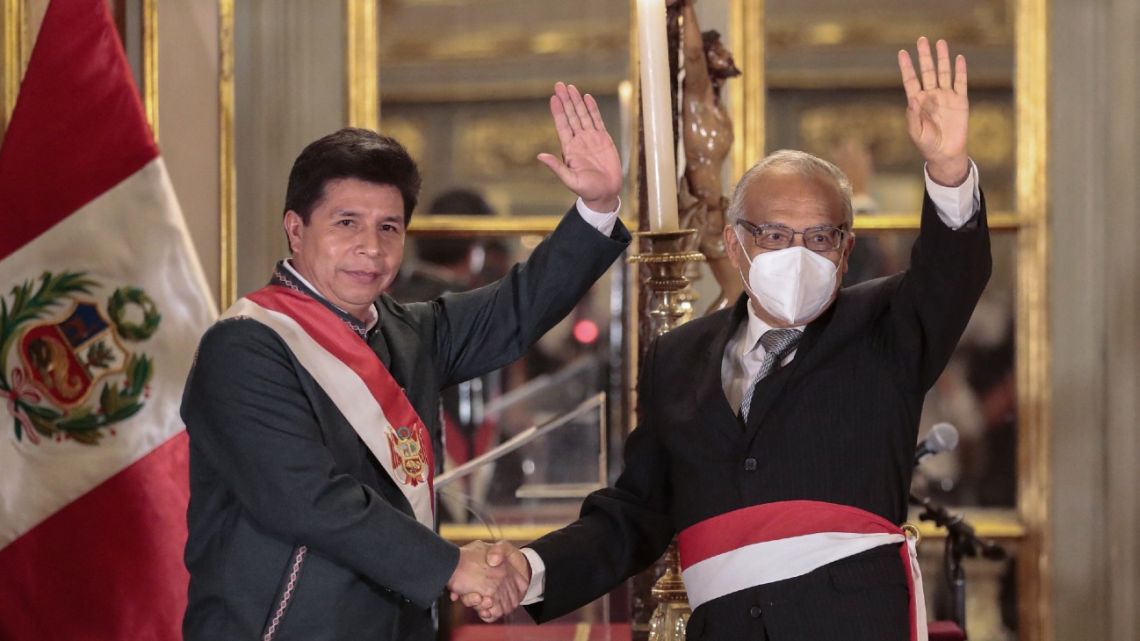 This handout picture released by the Peruvian Presidency shows Peru's President Pedro Castillo (left) congratulating Aníbal Torres after the latter was sworn-in as his Chief of Staff in Lima, on February 8, 2022. 