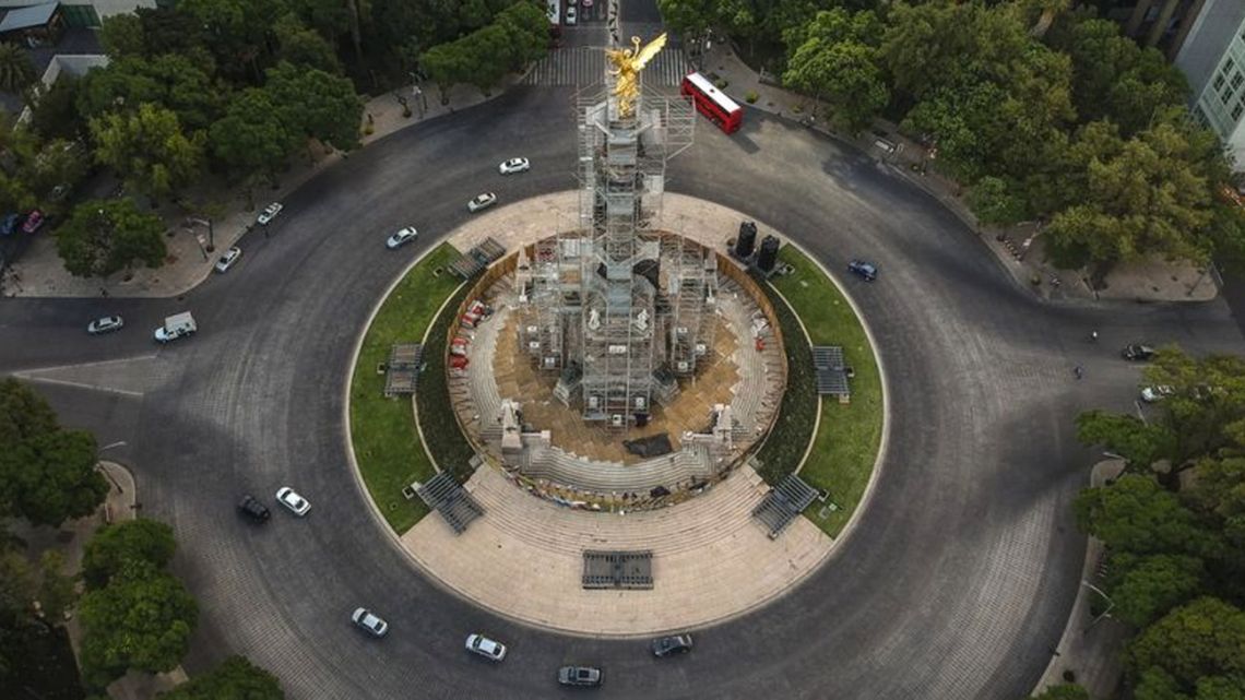 Vehicles travel along a nearly empty Reforma Avenue past the Angel of Independence monument in an aerial photograph taken over in Mexico City, Mexico, on Tuesday, June 2, 2020.