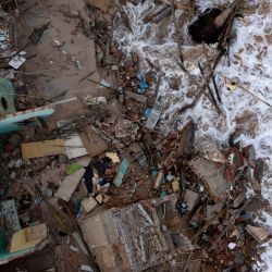 Aerial view of a man collecting debris from a house that fell the day before at Atafona beach in São João da Barra, Rio de Janeiro, Brazil, on February 7, 2022. 