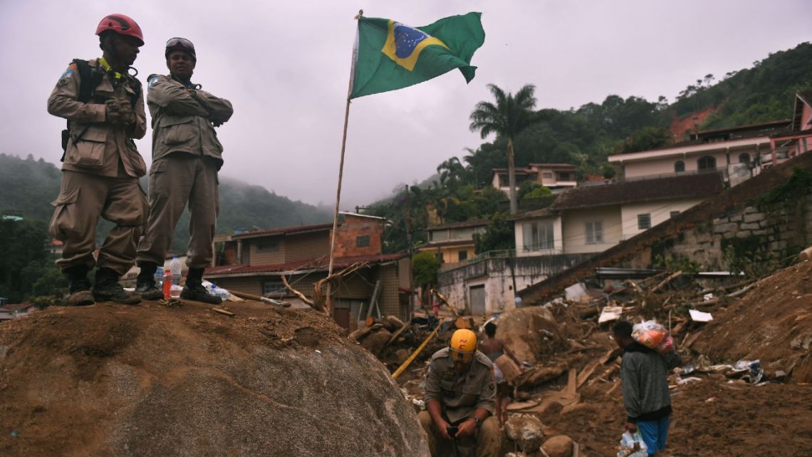In this file photo taken on February 19, 2022 firefighters are seen during a rescue mission after a giant landslide at Caxambu neighborhood in Petropolis, Brazil. The death toll from flash floods and landslides that hit the Brazilian city of Petropolis has risen to 182, authorities said on February 22, 2022, one week after torrential rains lashed the scenic tourist town. MAURO PIMENTEL / AFP