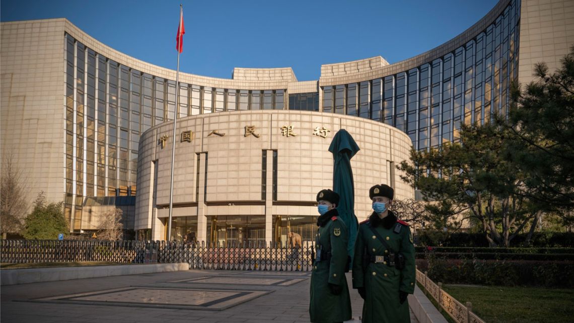 People's Liberation Army soldiers stand in front of the People's Bank of China (PBOC) in Beijing, China, on Monday, December 13, 2021.