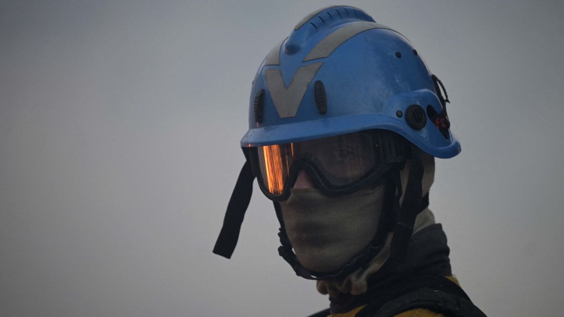 Fire is reflected in the googles of a firefighter while controlling the burned field to fight the wildfires of native forest at Paraje Uguay, Corrientes Province on February 22, 2022 near Ibera National Park.