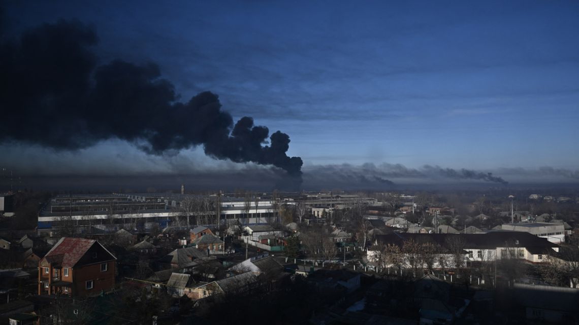 Black smoke rises from a military airport in Chuguyev near Kharkiv on February 24, 2022. Russian President Vladimir Putin announced a military operation in Ukraine today with explosions heard soon after across the country and its foreign minister warning a "full-scale invasion" was underway. 