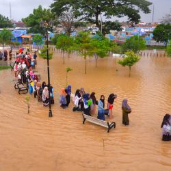 La gente vadea las aguas mientras evacua tras las inundaciones en Serang, provincia de Banten, Indonesia. | Foto:DZIKI OKTOMAULIYADI / AFP