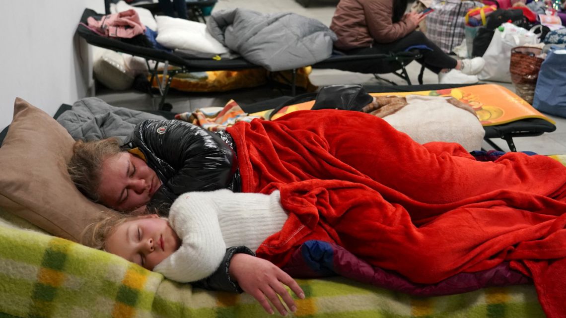 Refugees from Ukraine rest as they wait for transportion to further destinations, on March 4, 2022 in an empty shopping centre in Przemysl, Poland. More than one million people have fled Ukraine into neighbouring countries since Russia launched its full-scale invasion just a week ago. 