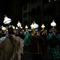 Las personas desfilan durante la tradicional procesión "Morgenstreich" que da comienzo al carnaval de Basilea. | Foto:SEBASTIEN BOZON / AFP
