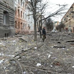 Un peatón camina entre los escombros de una calle tras un bombardeo en la segunda ciudad más grande de Ucrania, Kharkiv. | Foto:SERGEY BOBOK / AFP
