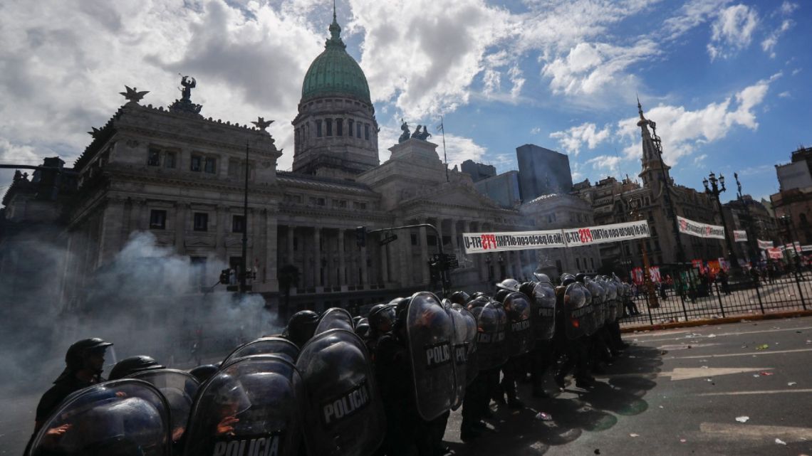 Riot police take position after clashes erupted during a protest against the agreement between the Argentine government and the International Monetary Fund outside the Congress in Buenos Aires on March 10, 2022. 