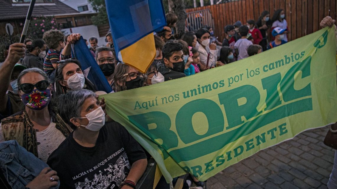 Supporters of Chilean president-elect Gabriel Boric wait for him outside the Cerro Castillo summer presidential palace in Vina del Mar, Chile, on March 10, 2022, the day ahead of his inauguration. 