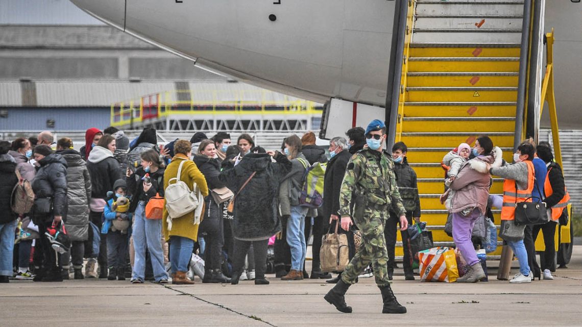 Ukrainian refugees prepare to leave their country following the invasion by the Russian Federation.