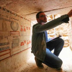 Un arqueólogo muestra la pintura mural en una antigua tumba descubierta en los sitios arqueológicos de Saqqara, en el suroeste de El Cairo, Egipto. El Ministerio de Turismo y Antigüedades de Egipto anunció el descubrimiento de cinco tumbas antiguas de 4.000 años de antigüedad en los sitios arqueológicos de Saqqara. | Foto:Xinhua/Sui Xiankai