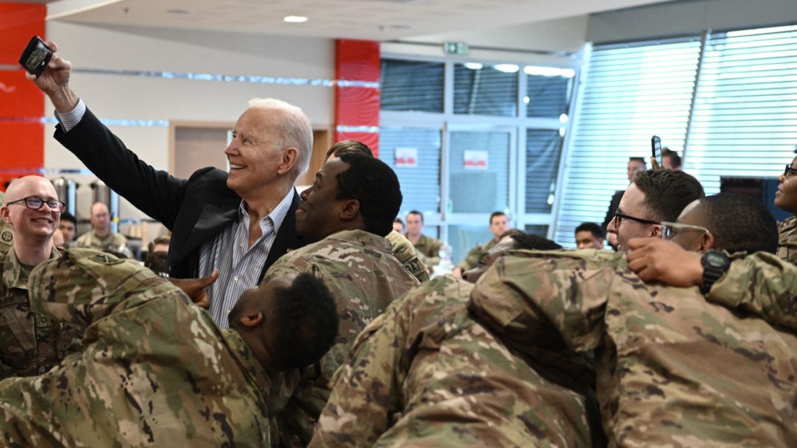 US President Joe Biden takes a selfie photo as he meets service members from the 82nd Airborne Division, who are contributing alongside Polish Allies to deterrence on the Alliance’s Eastern Flank, in the city of Rzeszow in southeastern Poland, around 100 kilometres (62 miles) from the border with Ukraine, on March 25, 2022. 