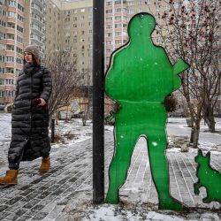 Una mujer camina a un perro más allá de la llamada "Instalación de la gente a un soldado ruso" apodó la "gente educada" creada por los residentes en el patio trasero de su edificio de apartamentos en la ciudad de Podolsk, fuera de Moscú.  | Foto:AFP