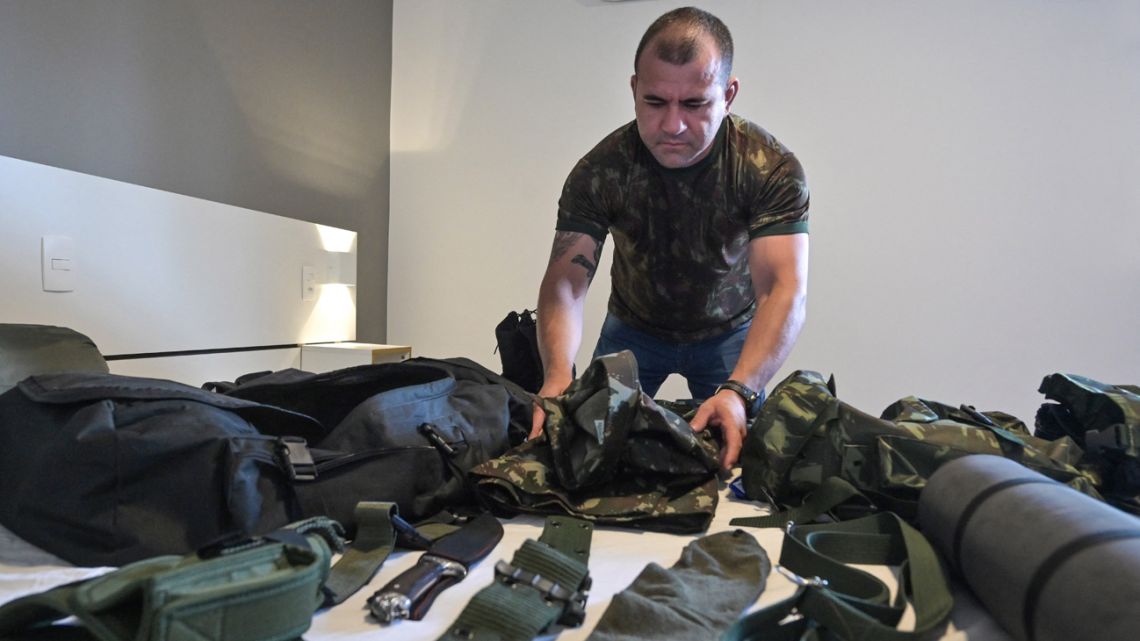 Former Brazilian military police officer Saulo packs his bag with essential belongings to go fight in Ukraine, during an interview with AFP, in São Paulo, Brazil, on March 17, 2022.