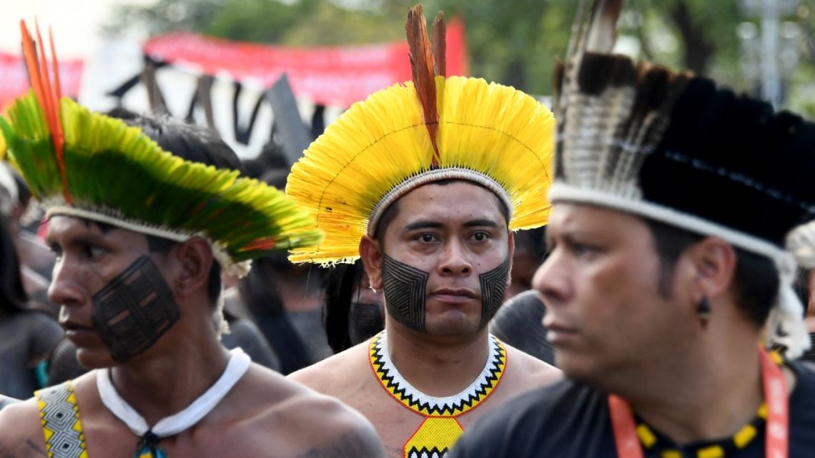 Brazilian indigenous people from various tribes take part in a protest against President Jair Bolsonaro in front of the National Congress in Brasília on April 9, 2022.