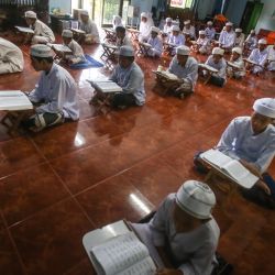 Huérfanos leen ejemplares del Corán durante el mes sagrado islámico del Ramadán en el Majamma Nuruljinan en Pattani, en el sur de Tailandia. | Foto:TUWAEDANIYA MERINGING / AFP
