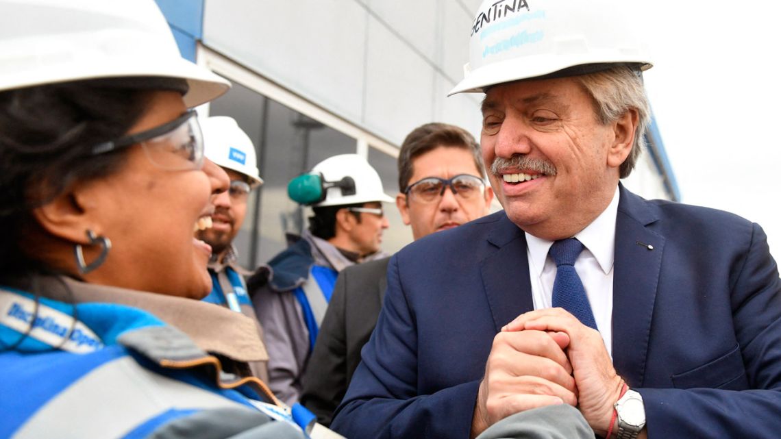 Handout photo released by the Presidency shows President Alberto Fernández (right) greeting workers at a YPF oilfield in Loma Campana, Vaca Muerta formation, Neuquén, Argentina, on April 21, 2022. 