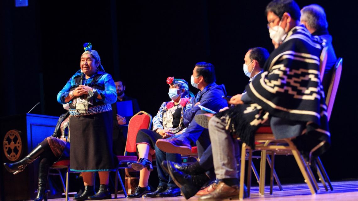 Mapuche indigenous leader Ana Llao (L) speaks during a forum organized by the Association of Municipalities with Mapuche Mayors (AMCAM) in Temuco, Chile, on April, 21 2022. Communities of the Mapuche people sought internal agreements in the southern city of Temuco to resolve, despite their differences, the "historical debt" that they consider the Chilean state owes them.