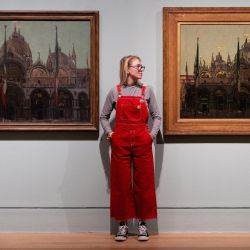 Un visitante posa con obras de arte del artista británico de origen alemán Walter Sickert durante una vista de prensa en la Tate Britain en Londres. | Foto:NIKLAS HALLE'N / AFP