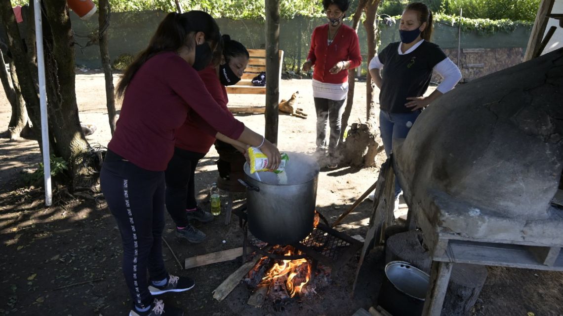 Members of the Barrios de Pie social organisation prepare a stew at the 'El Lucero' soup kitchen in Belén de Escobar, Buenos Aires Province, on April 21, 2022.