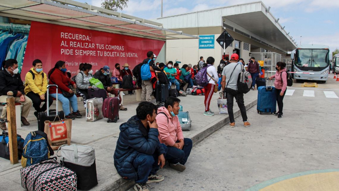 Chilean and Peruvian citizens wait to cross the border into Peru at the Chacalluta border crossing in Chacalluta, Chile, on May 1, 2022. Chile reopened this Sunday land border crossings with Argentina, Bolivia and Peru that had been closed since March 17, 2020 as a preventive measure after the arrival of COVID-19 in the country, reported the Ministry of the Interior.
