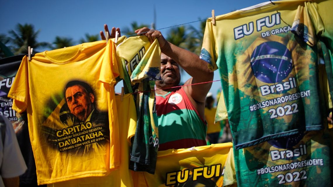 A vendor sells T-shirts as Bolsonaro supporters demonstrate in support of the president and his controversial ally, deputy Daniel Silveira, in Rio de Janeiro, May 1, 2022.