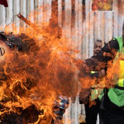 Grupos defensores de los migrantes prenden fuego a una piñata con la imagen del canciller mexicano Marcelo Ebrard durante una manifestación junto al muro fronterizo entre México y Estados Unidos en Playas de Tijuana, México. | Foto:Guillermo Arias / AFP