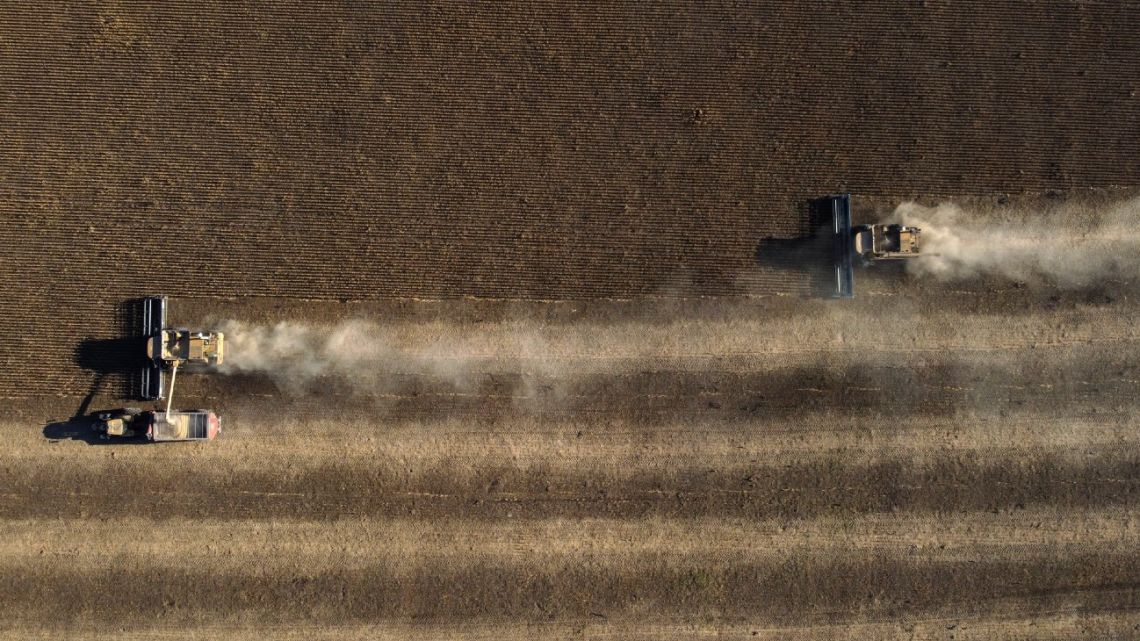 Aerial view of combine harvesters harvesting a soy field in Lobos, some 100 kilometres southwest of Buenos Aires, on April 29, 2022. 