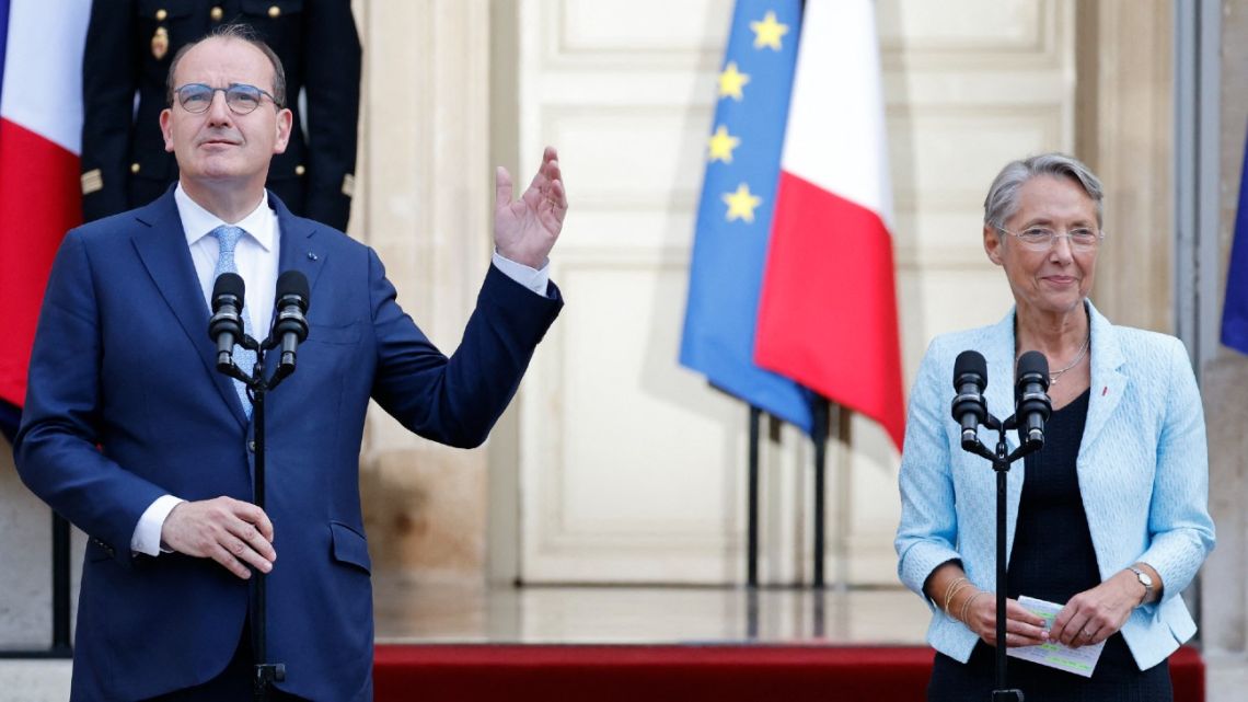 France's outgoing Prime Minister Jean Castex (L) gestures towards his successor, former Labour Minister Elisabeth Borne (R), during a handover ceremony in Paris on May 16, 2022. 