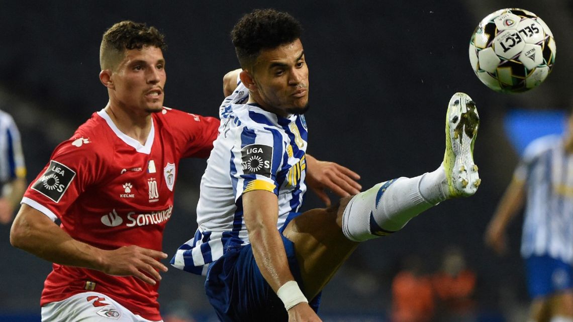 In this file photo taken on April 3, 2021, Santa Clara's Portuguese defender Rafael Ramos (L) challenges FC Porto's Colombian midfielder Luis Diaz during their Portuguese League football match at the Dragão stadium.