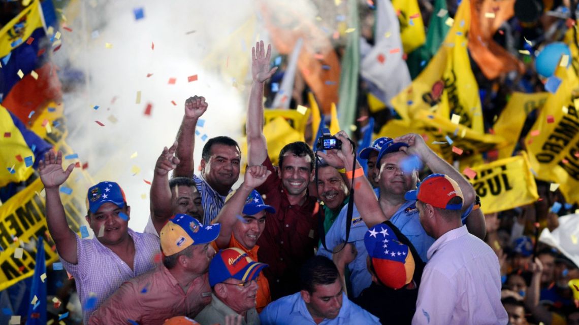  In this file photo taken in September of 2012, Venezuelan opposition presidential candidate Henrique Capriles (C) cheers at the end of a campaign rally in Barinas, western Venezuela. 