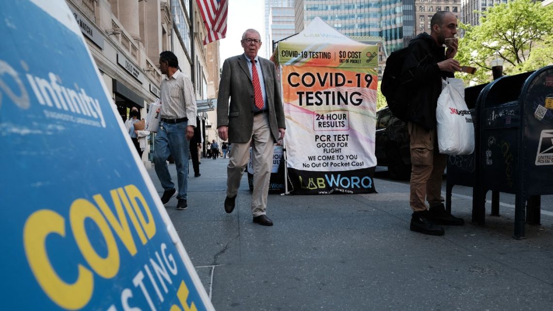 People walk past a Covid testing site on May 17, 2022, in New York City, NY, USA.