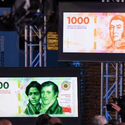 The new series of Argentine peso notes are displayed on screens during the presentation at the Bicentennial Museum of Casa Rosada House of Government in Buenos Aires on May 23, 2022. 