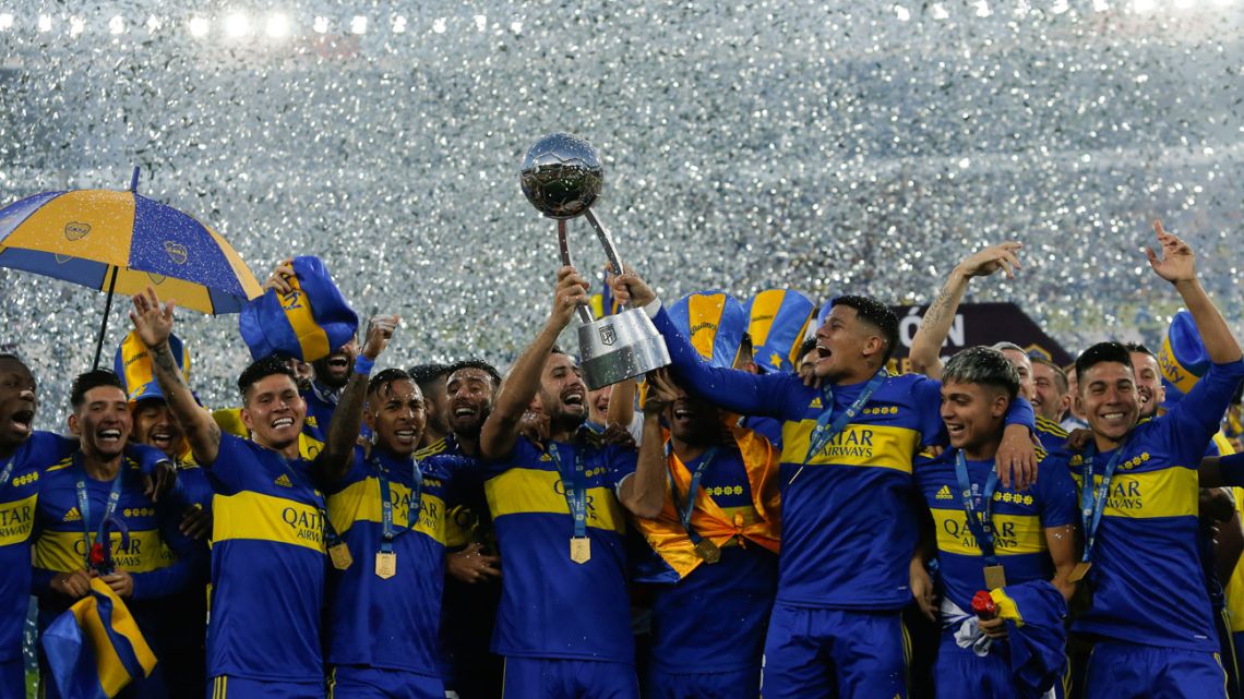 Boca Juniors' players celebrate with the trophy after defeating Tigre in the Argentine Professional Football League final match, at Mario Alberto Kempes stadium in Córdoba on May 22, 2022. 
