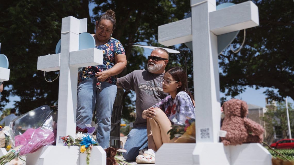 People visit a memorial in the town square for victims of Tuesday's mass shooting at Robb Elementary School on May 26, 2022 in Uvalde, Texas, USA.