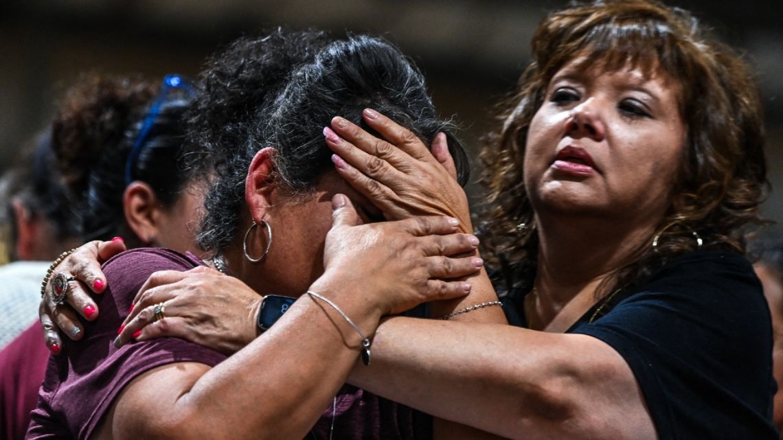 A woman cries as she attends the vigil for the victims of the mass shooting at Robb Elementary School in Uvalde, Texas on May 25, 2022. The tight-knit Latino community of Uvalde was wracked with grief Wednesday after a teen in body armor marched into the school and killed 19 children and two teachers, in the latest spasm of deadly gun violence in the US.