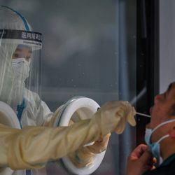 Un trabajador de la salud toma una muestra de hisopo de un hombre durante un bloqueo del coronavirus Covid-19 en el distrito de Jing'an en Shanghai. | Foto:HECTOR RETAMAL / AFP