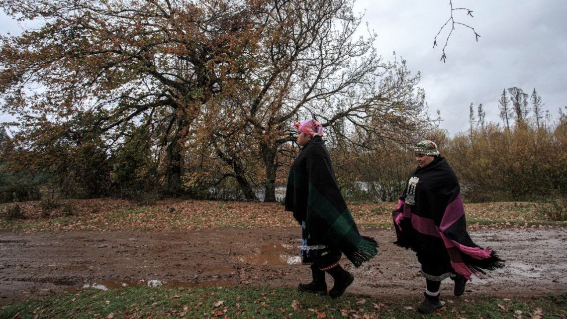 Mapuche indigenous Carolina Soto (R) and her daughter Barbara Farias walk in Collipulli, Temuco, Chile, on May 20, 2022.