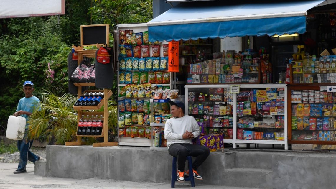 A kiosk seller waits for customers at Cafetal neighbourhood in Caracas on June 1, 2022. They are light years away from the good old days, but US imports of food and agricultural products are growing in Venezuela.