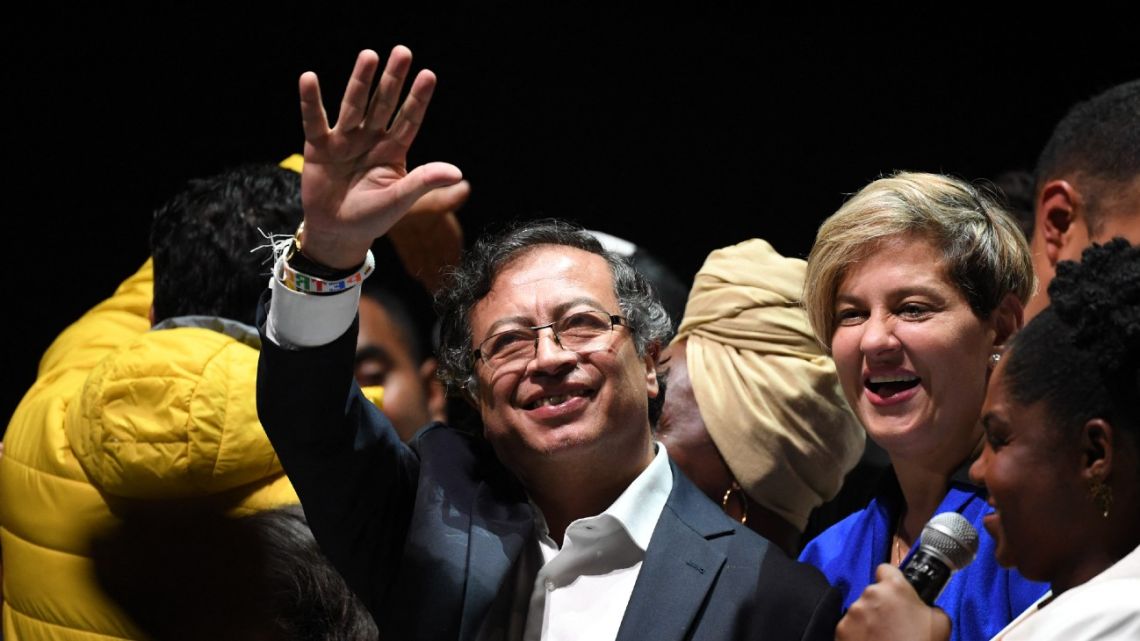 Newly elected Colombian President Gustavo Petro (centre) celebrates next to his wife Verónica Alcocer and his running-mate Francia Márquez at the Movistar Arena in Bogotá, on June 19, 2022 after winning the presidential run-off election on June 19, 2022. 