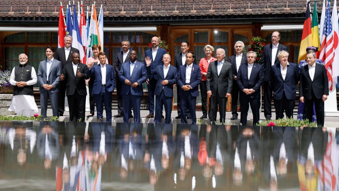 (L-R, front row) India's Prime Minister Narendra Modi , Canada's Prime Minister Justin Trudeau, South Africa's President Cyril Ramaphosa, France's President Emmanuel Macron, Senegal's President Macky Sall, German Chancellor Olaf Scholz, Indonesia's President Joko Widodo, US President Joe Biden, Argentina's President Alberto Fernandez, Britain's Prime Minister Boris Johnson, Italy's Prime Minister Mario Draghi, (L-R, back row) Secretary-General of the OECD Mathias Cormann, Managing Director of the International Monetary Fund (IMF) Kristalina Georgieva, OMS managing director Tedros Adhanom Ghebreyesus, European Council President Charles Michel, Japan's Prime Minister Fumio Kishida, European Commission President Ursula von der Leyen, head of the International Energy Agency (IEA) Fatih Birol, World Bank president David Malpass and World Trade Organization Director-General Ngozi Okonjo-Iweala pose for a family photo on June 27, 2022 at Elmau Castle, southern Germany, where the German Chancellor hosts a summit of the Group of Seven rich nations (G7). Germany will host the 48th G7 Summit from June 26 to June 28 at Elmau Castle, southern Germany. 